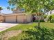 Inviting two-story home with a large front lawn, three-car garage, and mature landscaping at 1870 Desert Forest Way, Henderson, NV 89012