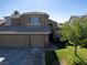 Inviting two-story home featuring a three car garage and well manicured lawn at 1870 Desert Forest Way, Henderson, NV 89012