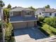 Attractive two-story home with a three-car garage, mature landscaping, and a well-maintained lawn at 1870 Desert Forest Way, Henderson, NV 89012