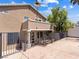 Rear exterior view featuring a fenced patio and balcony on a two-story home with neutral stucco and a gable roof at 1870 Desert Forest Way, Henderson, NV 89012