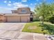 Charming two-story home featuring a spacious three-car garage and well-maintained front yard at 1870 Desert Forest Way, Henderson, NV 89012