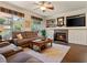 Cozy living room featuring a fireplace, built-in shelving, and an abundance of natural light at 1870 Desert Forest Way, Henderson, NV 89012