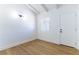 Cozy bedroom featuring wood flooring, white walls, and ample natural light at 1916 Howard Ave, Las Vegas, NV 89104