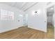 Bright bedroom with wood-look floors features access to two hallways and a window at 1916 Howard Ave, Las Vegas, NV 89104