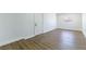 Bright bedroom featuring wood-look flooring, white walls and trim, and a window at 1916 Howard Ave, Las Vegas, NV 89104