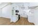 Modern eat-in kitchen featuring white cabinets, stainless appliances, and wood flooring at 1916 Howard Ave, Las Vegas, NV 89104