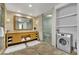 Bathroom with double vanity, glass shower, and convenient in-unit washer/dryer at 2000 N Fashion Show Dr # 2222, Las Vegas, NV 89109