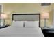 This bedroom features a bed with white linens and two bedside lamps at 2000 N Fashion Show Dr # 2222, Las Vegas, NV 89109