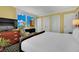 Beautiful bedroom features a dresser, TV, chair, and a view of the city at 2000 N Fashion Show Dr # 2222, Las Vegas, NV 89109