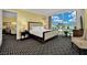 Spacious main bedroom featuring a large bed, nightstand, and amazing city views from the large windows at 2000 N Fashion Show Dr # 2222, Las Vegas, NV 89109