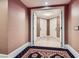 Hallway view with carpet and neutral walls leading to white doors and tile flooring at 2000 N Fashion Show Dr # 2308, Las Vegas, NV 89109