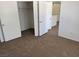 Bedroom with carpet flooring and an open closet with double doors at 2019 Rancho Lake Dr # 102, Las Vegas, NV 89108