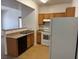 Open concept kitchen with wood cabinets and white appliances at 2019 Rancho Lake Dr # 102, Las Vegas, NV 89108