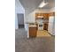 Open concept kitchen with wood cabinets and white appliances at 2019 Rancho Lake Dr # 102, Las Vegas, NV 89108