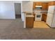 Open concept kitchen with wood cabinets and white appliances at 2019 Rancho Lake Dr # 102, Las Vegas, NV 89108