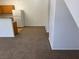 View of the living room featuring neutral carpet and white walls, adjacent to the kitchen at 2019 Rancho Lake Dr # 102, Las Vegas, NV 89108