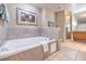 Luxurious bathroom featuring a soaking tub and tiled surround, with separate shower at 211 E Flamingo Rd # 402, Las Vegas, NV 89169