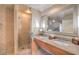 Elegant bathroom featuring dual sinks, a glass-enclosed shower, and luxury fixtures at 211 E Flamingo Rd # 402, Las Vegas, NV 89169