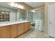 Bright bathroom featuring dual sinks, framed mirrors, and a glass-enclosed shower with bench at 2166 Alyssa Jade Dr, Henderson, NV 89052
