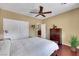 This cozy bedroom includes hardwood floors, a ceiling fan, and convenient access to the en-suite bathroom at 2166 Alyssa Jade Dr, Henderson, NV 89052
