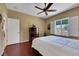 Bright bedroom featuring a view of the pool area, complemented by hardwood floors and a ceiling fan at 2166 Alyssa Jade Dr, Henderson, NV 89052