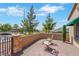 Inviting front courtyard with pavers, seating, mature trees, and desert landscaping at 2166 Alyssa Jade Dr, Henderson, NV 89052
