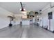 Clean and organized garage with ample storage, epoxy flooring, and a well-lit workspace at 2166 Alyssa Jade Dr, Henderson, NV 89052