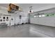 Organized garage with epoxy flooring, storage shelves, and well-lit space for multiple vehicles at 2166 Alyssa Jade Dr, Henderson, NV 89052