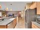 Open kitchen view showing stainless appliances, breakfast bar, and open access to the living room at 2166 Alyssa Jade Dr, Henderson, NV 89052