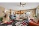 Open living room with ceiling fan, decorative rug, neutral colors and view of kitchen at 2166 Alyssa Jade Dr, Henderson, NV 89052
