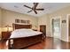Warm and inviting main bedroom with hardwood floors, ceiling fan, and attached bath at 2166 Alyssa Jade Dr, Henderson, NV 89052