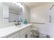 Modern bathroom with white vanity, stylish tile flooring, and shower with accessibility bar at 2241 Tall Pine Dr, Las Vegas, NV 89108