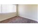 Neutral bedroom with carpet, base trim, and large window for natural light at 2241 Tall Pine Dr, Las Vegas, NV 89108