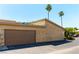 Home exterior showcasing a garage door, driveway, and landscaping, complemented by lush palm trees at 2241 Tall Pine Dr, Las Vegas, NV 89108