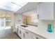 Kitchen boasts stainless steel appliances, white cabinets, and a view of the dining area at 2241 Tall Pine Dr, Las Vegas, NV 89108