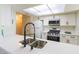 Bright kitchen features stainless steel appliances, white cabinets, and sleek countertops at 2241 Tall Pine Dr, Las Vegas, NV 89108