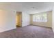 Spacious main bedroom with neutral carpet and large windows for plenty of natural light at 2241 Tall Pine Dr, Las Vegas, NV 89108