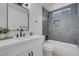 A modern bathroom features a stylish tub, elegant fixtures, and white vanity, plus tiled shower at 2832 Sing Song Way, Las Vegas, NV 89106