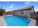 Backyard pool with clear blue water and stone surround features convenient built-in steps for easy access and enjoyment at 2832 Sing Song Way, Las Vegas, NV 89106