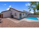 Inviting backyard pool with clear blue water, surrounded by a stone patio, offers a refreshing oasis for relaxation and entertainment at 2832 Sing Song Way, Las Vegas, NV 89106