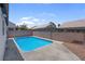 Private backyard pool, enclosed by a brick fence, offers a serene escape for relaxation and recreation at 2832 Sing Song Way, Las Vegas, NV 89106