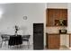 Compact kitchenette with mini-fridge, sink, and seating for two makes efficient use of the space at 30 Strada Di Villaggio # 227, Henderson, NV 89011