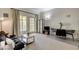 Bright living room featuring a comfortable sofa, dining table, and balcony access at 30 Strada Di Villaggio # 227, Henderson, NV 89011