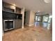 Compact bar area with a mini-fridge, cabinets, and dark backsplash adjacent to a spacious living area at 3142 Bel Air Dr, Las Vegas, NV 89109