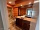 Bathroom with patterned wallpaper and marble vanity featuring a vessel sink and dark wood cabinetry at 3142 Bel Air Dr, Las Vegas, NV 89109