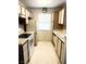 Functional kitchen with white appliances, laminate countertops, and paneled wood cabinets at 3150 Soft Breezes Dr # 1192, Las Vegas, NV 89128
