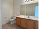 Neutral bathroom features a toilet, vanity with sink, and a large mirror at 338 Brilliant Summit Cir, Henderson, NV 89052