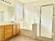 Bright bathroom featuring tile flooring and a glass-enclosed shower/tub at 338 Brilliant Summit Cir, Henderson, NV 89052