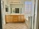 Well-lit bathroom features double vanity, a tub, and tiled floors for a clean aesthetic at 338 Brilliant Summit Cir, Henderson, NV 89052