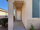 Inviting entryway with a covered porch and neutral stucco exterior at 338 Brilliant Summit Cir, Henderson, NV 89052